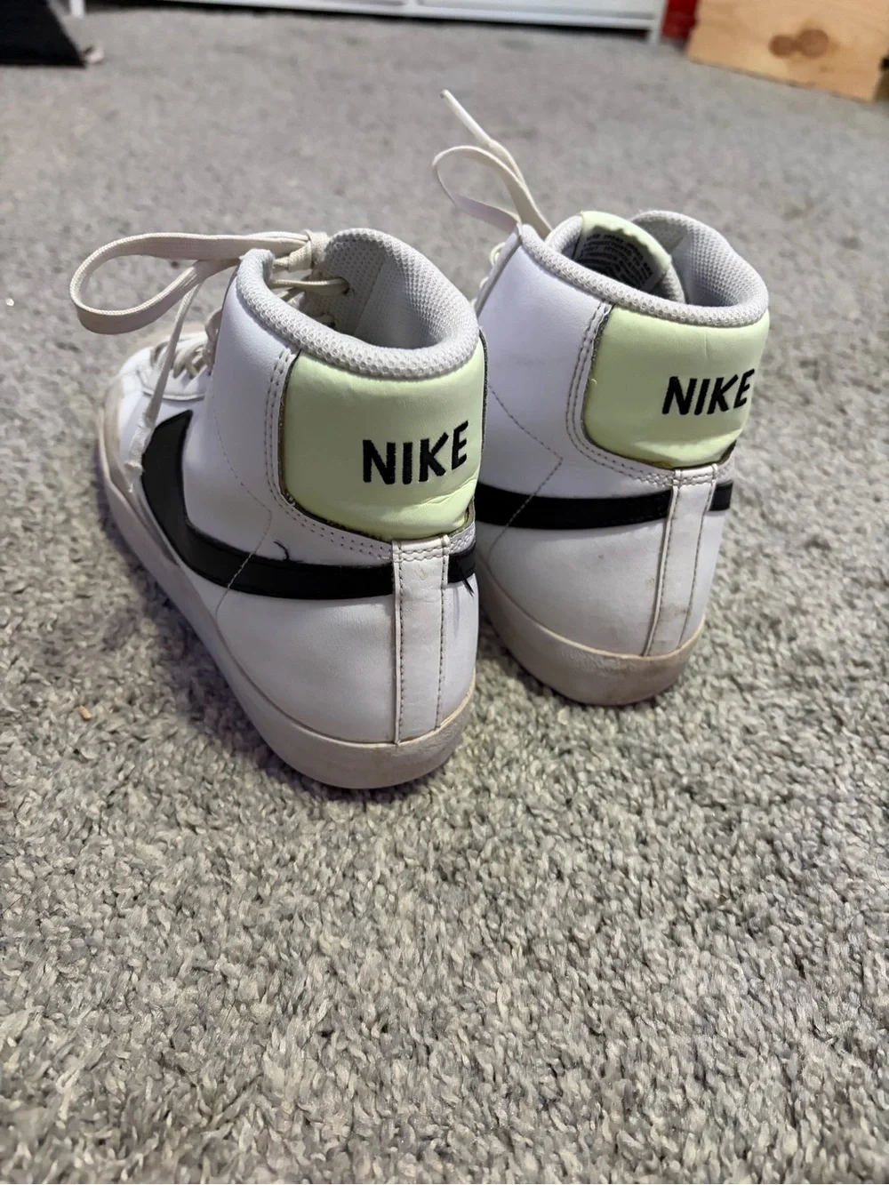 Nike White High-Top Sneakers with Black Swoosh